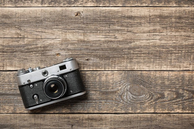 Retro film camera on wooden background