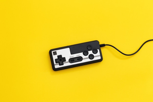 Retro gamepad on color background, game controller