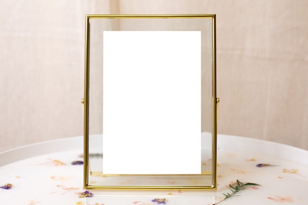 Retro gold or bronze frame with scuffs aged for photos, text, images or paintings on white table side view