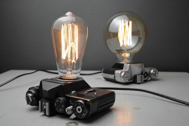 Retro lamp from an old camera with an Edison lamp on gray