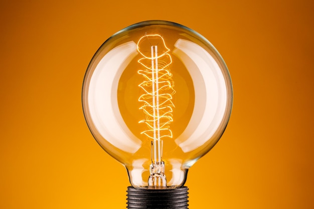 Retro lamp on a yellow background The concept of electricity