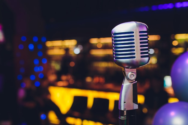 Retro microphone against blur colorful light restaurant