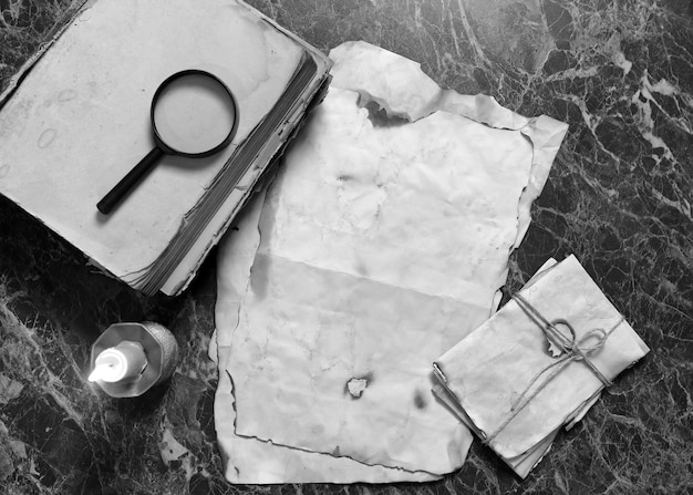 Retro papers and book on detective work table with tools background