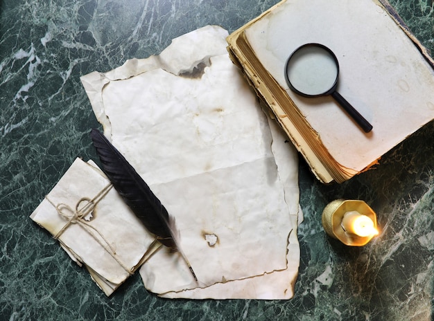 Retro papers and book on detective work table with tools background