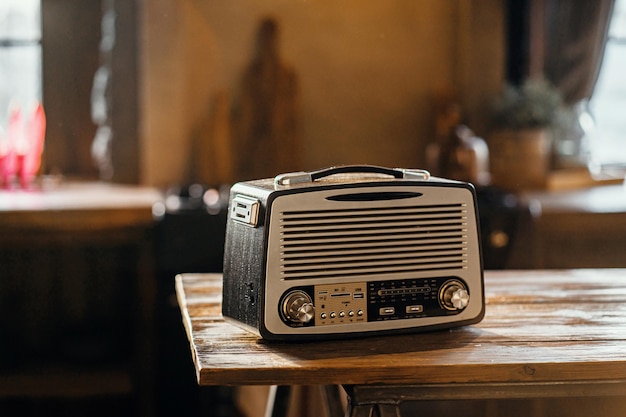 A retro radio player stands on a wooden table stylish kitchen in the village copy space