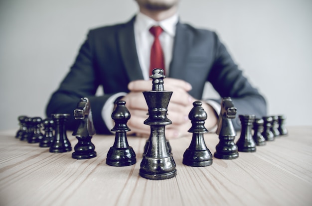 Retro style image of a businessman with clasped hands planning strategy 