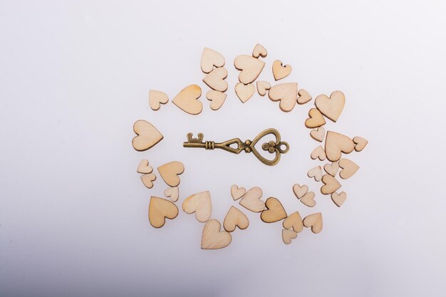 Retro style key on wooden hearts on white background