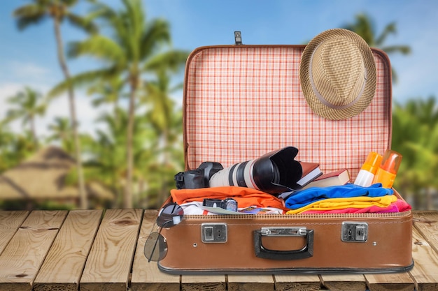 Retro suitcase with travel objects  on background