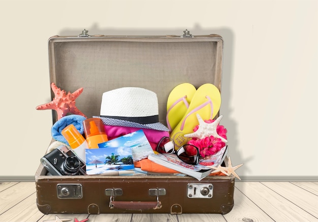 Retro suitcase with travel objects on  background