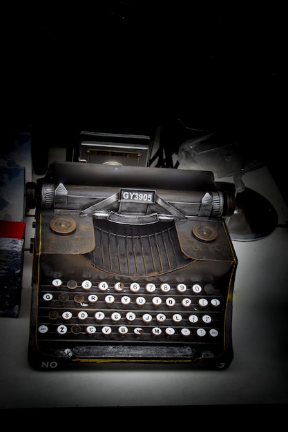 Retro syled tiny typewriter model on white background