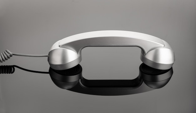 Retro telephone handset on dark background Contact us concept