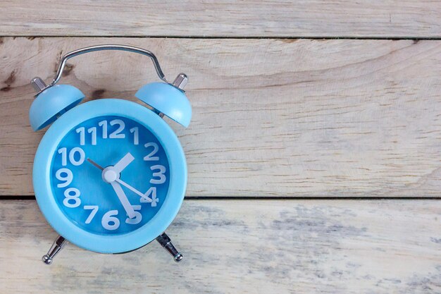 Retro vintage alarm clock on wood table background