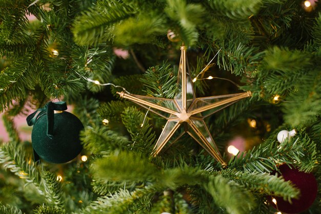 Retro vintage Christmas toy glass star on the tree with lights