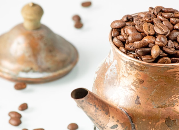 Retrostyle copper coffee pot filled to the top with coffee beans