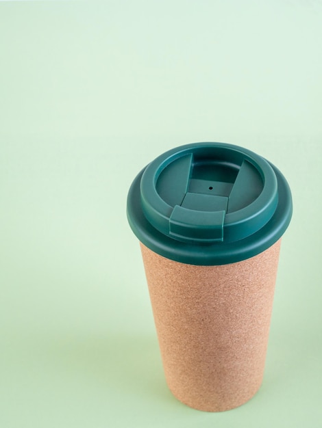 Photo reusable cup on green background environment and sustainability