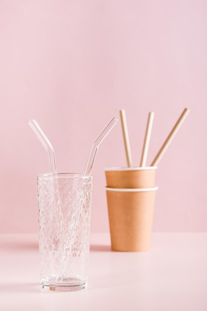 Photo reusable glass cup and straw vs paper cups and straws zero waste vertical view