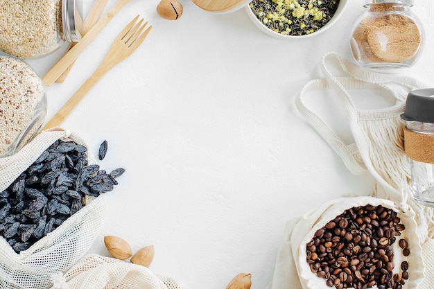 Reusable mesh produce bags full of nuts and dried fruits.  Glass jars with groats. Zero Waste Food Shopping.  Waste-free living