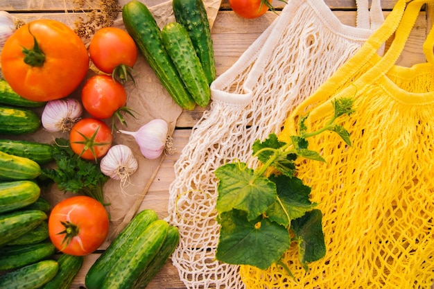 Reusable shopping bag string bag made of recycled materials on a wooden table among fresh vegetables No plastic Ecofriendly lifestyle