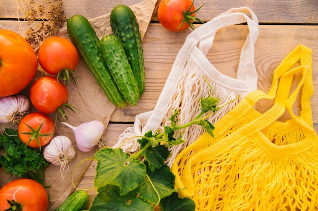 Reusable shopping bag string bag made of recycled materials on a wooden table among fresh vegetables No plastic Ecofriendly lifestyle