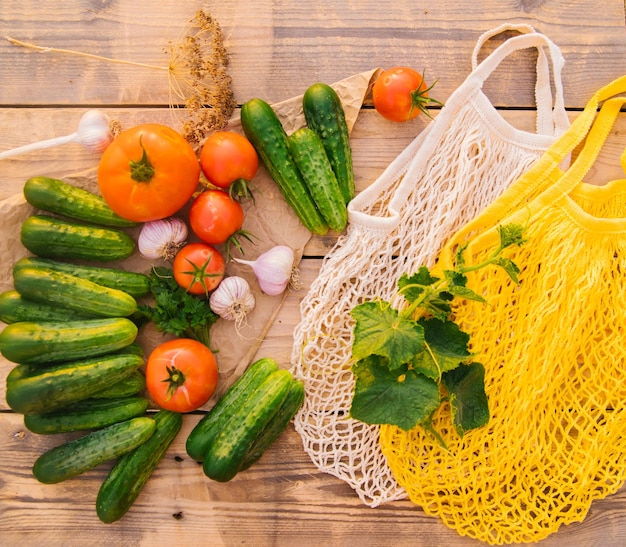 Reusable shopping bag string bag made of recycled materials on a wooden table among fresh vegetables No plastic Ecofriendly lifestyle