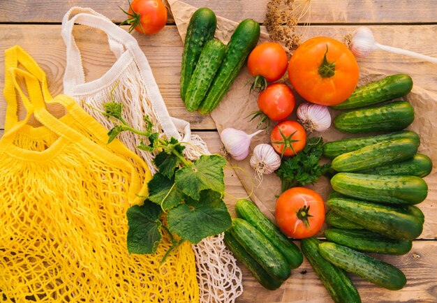 Reusable shopping bag string bag made of recycled materials on a wooden table among fresh vegetables No plastic Ecofriendly lifestyle