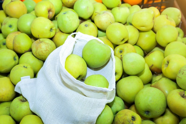 Reusable shopping bag with fruit. Zero waste. Ecologically and environmentally friendly packets. Canvas and linen fabrics. Save nature concept. No plastic single use in supermarkets.