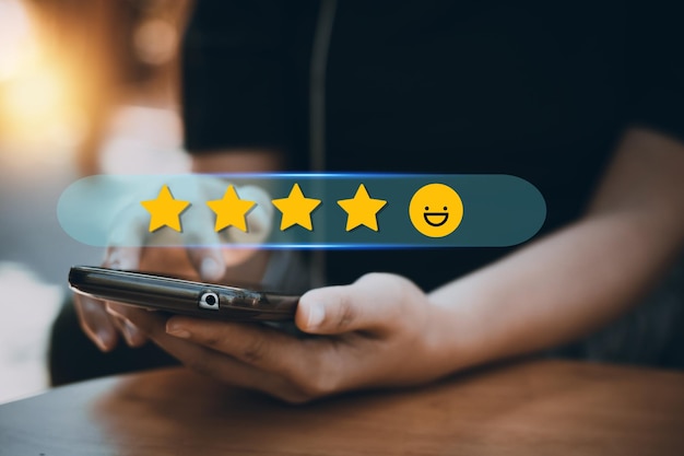 Review rating and feedback 5 stars the best and excellent admire by reviewer close up on customer hand pressing on smartphone screen with gold five star