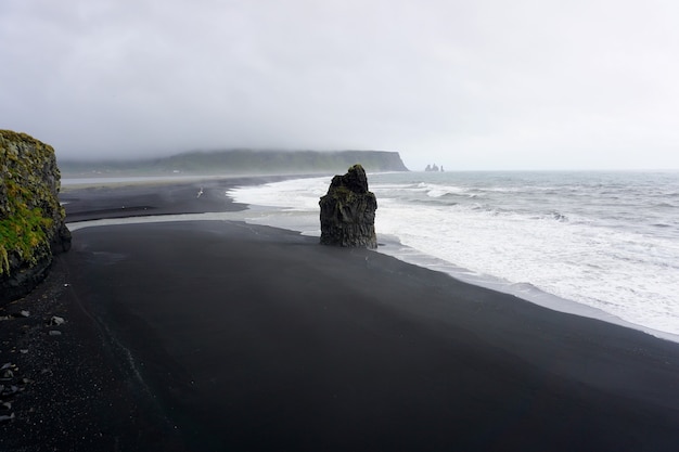 Reynisfjara volcanic black sand beach  in a rainy day. Vik, Iceland.