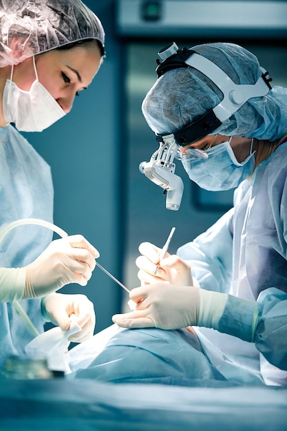 Rhinoplasty men the surgeons gloved hands hold the instruments during nose surgery doctor in gloves