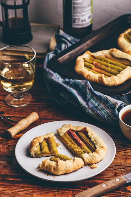 Rhubarb galette on plate with glass of wine