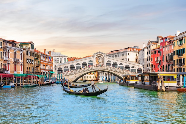 Rialto Bridge and gondoliers, a popular landmark of Venice, Italy.