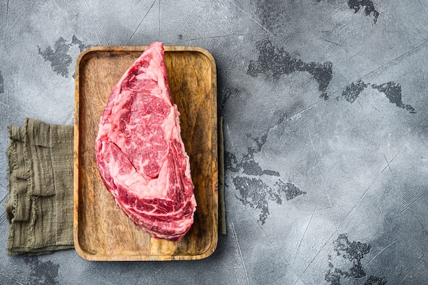 Rib eye beef meat cut raw set, on gray stone table, top view flat lay