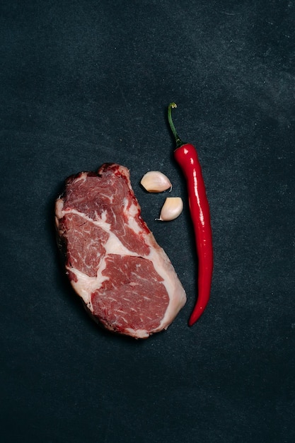 Rib eye steak on a black background.