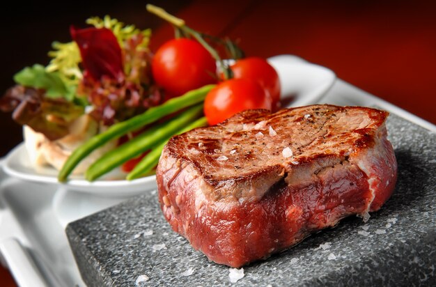 Rib-eye steak resting on the hot stone plate