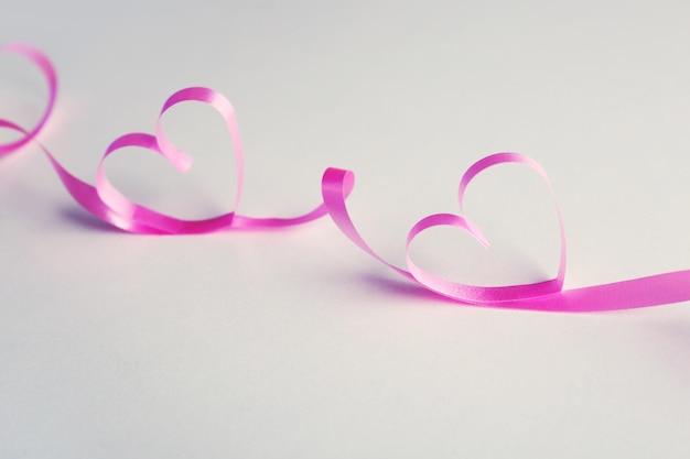 Ribbon shaped as heart on gray background