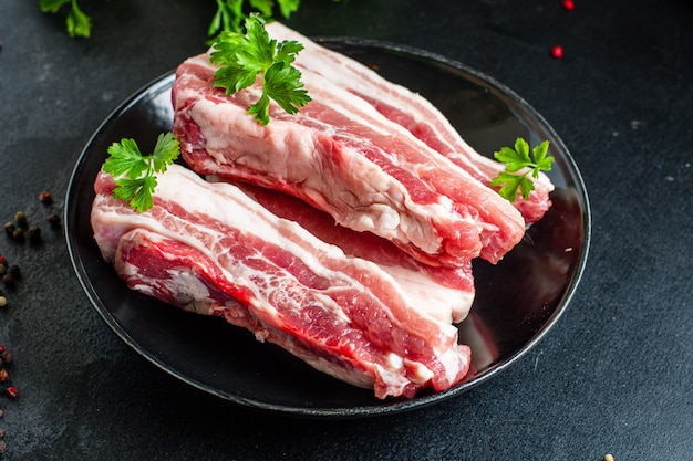 Ribs raw pork meat on the bone and lard fat grilled meat barbecue cook snack ready to eat