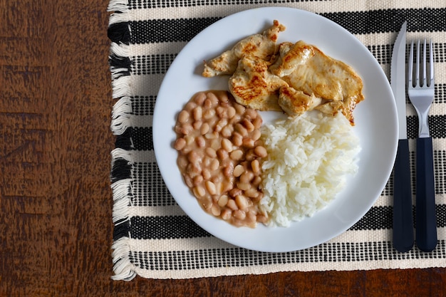 Rice, beans and grilled chicken fillet - top view.