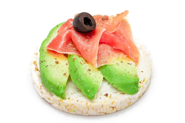 Rice cake sandwich with fresh avocado jamon and olives  isolated