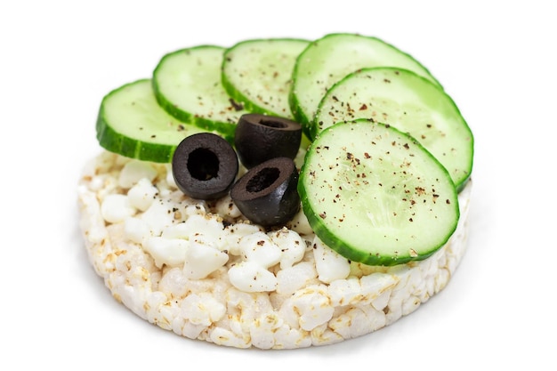 Rice cake sandwich with fresh cucumber cottage cheese and olives  isolated