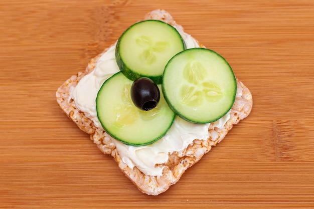 Rice cake sandwich with fresh cucumber cream cheese and olives