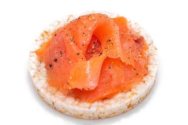 Rice cake sandwich with fresh salmon slices isolated on white