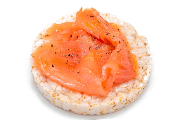 Rice cake sandwich with fresh salmon slices isolated on white