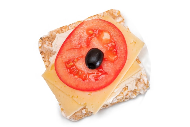 Rice cake sandwich with tomato cheese and olives isolated