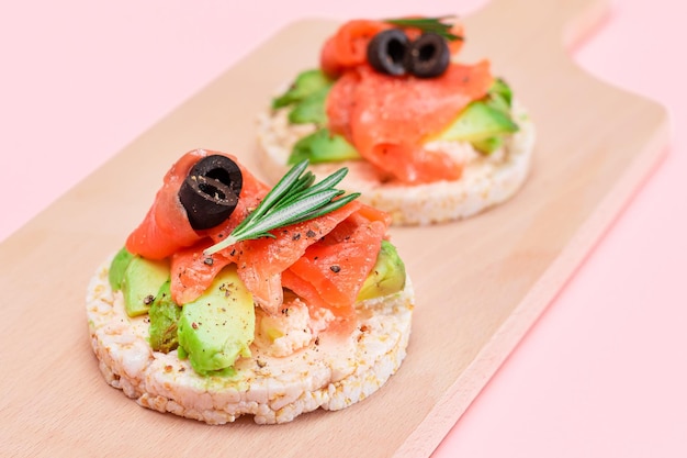 Rice cake sandwiches with fresh salmon avocado and olives