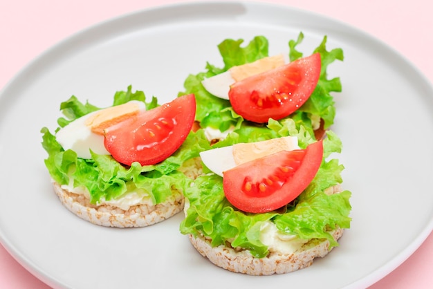 Rice cake sandwiches with tomato lettuce and egg