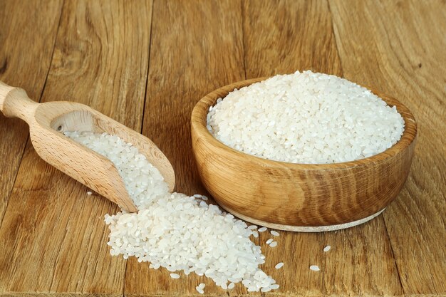 Rice camolino in a wooden bowl on the kitchen table