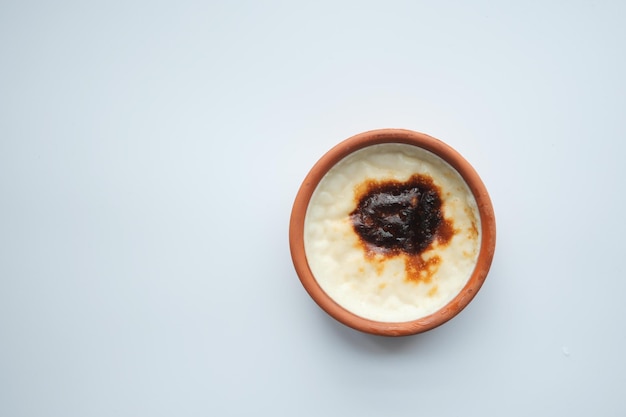 Rice Caramel pudding in a glass jar on table