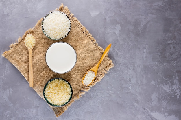 Rice milk and rice seeds on gray background