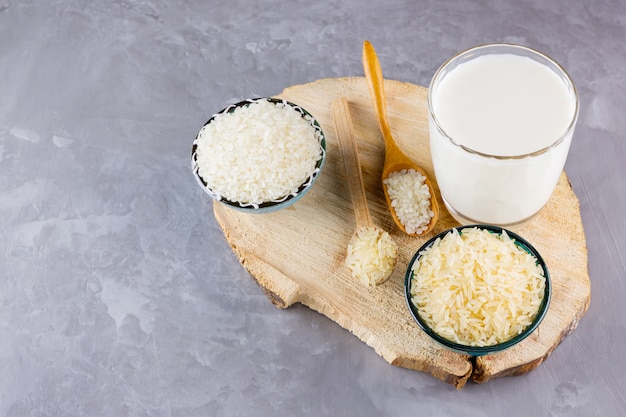 Rice milk and rice seeds on gray background