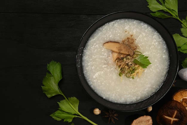 Rice porridge rice gruel or congee with shiitake mushroom slice ginger and scallion for breakfast or light meal